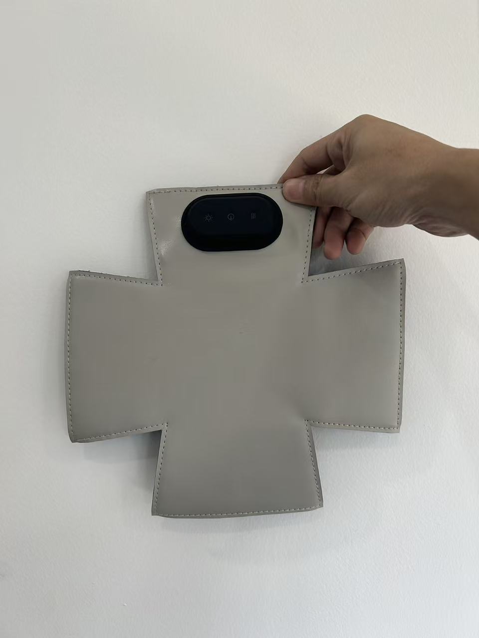 Back of the hair-care pad showing the onboard 3-button control module