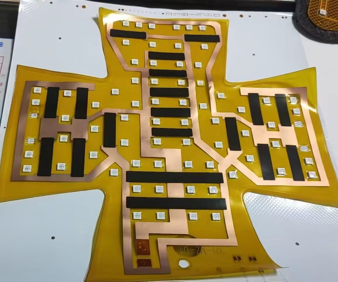 Bare flexible circuit of the hair-care pad: copper traces, graphene heating strips and LED beads on a cross-shaped FPC