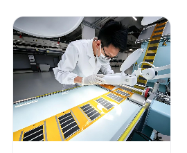 Engineer inspecting a graphene electrothermal film on a production line
